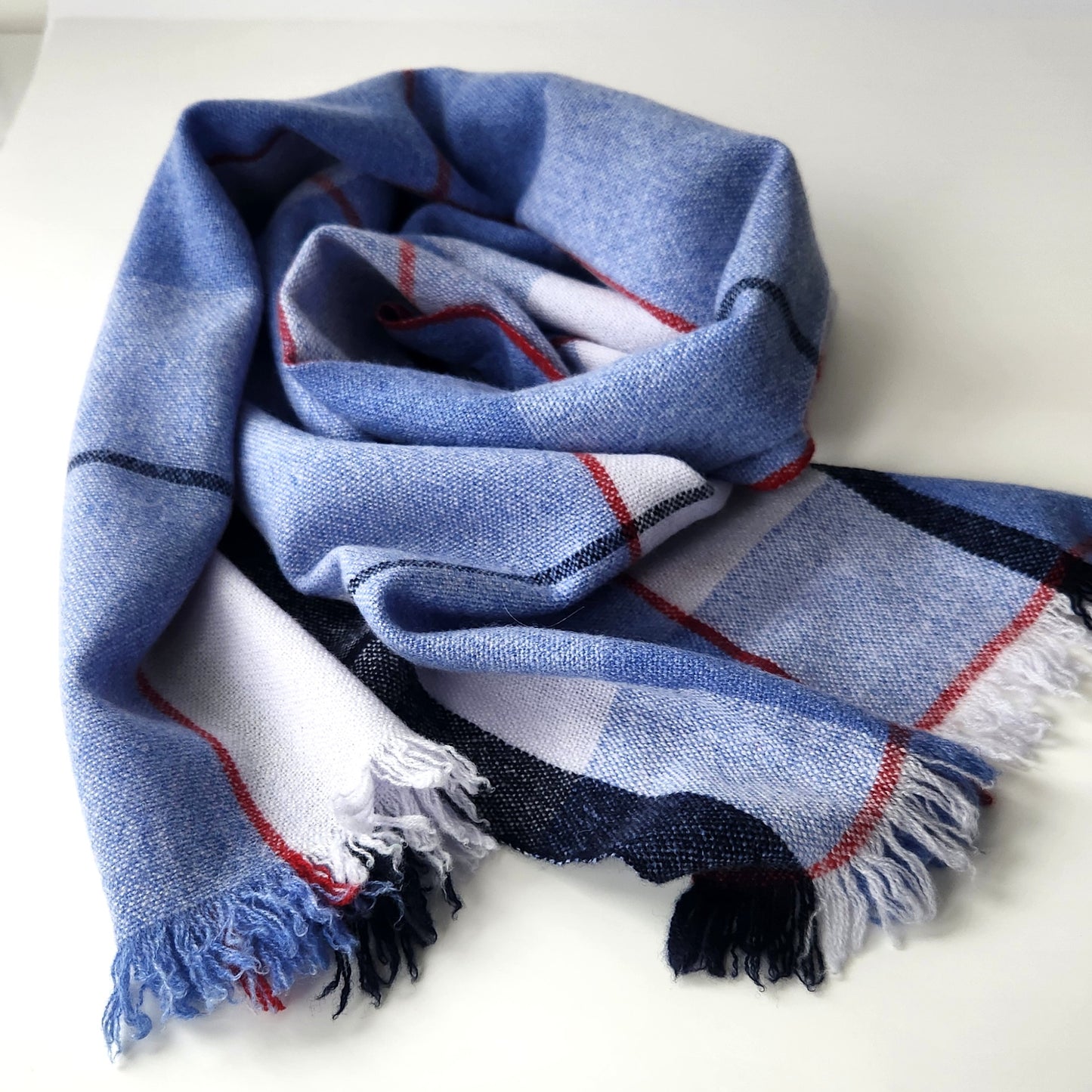 Blue plaid scarf with fringes on a white background